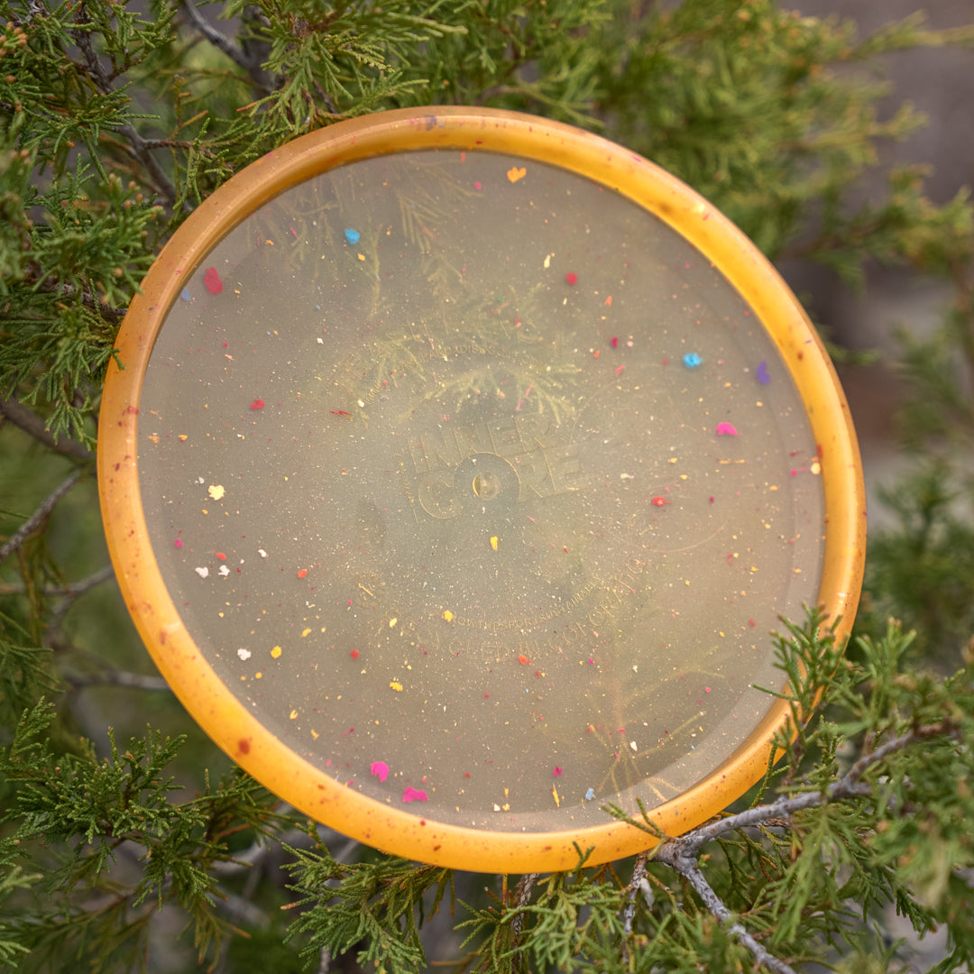 Outdoor shot of the sunstone Crocs Inner Core recycled sustainable disc golf disc
