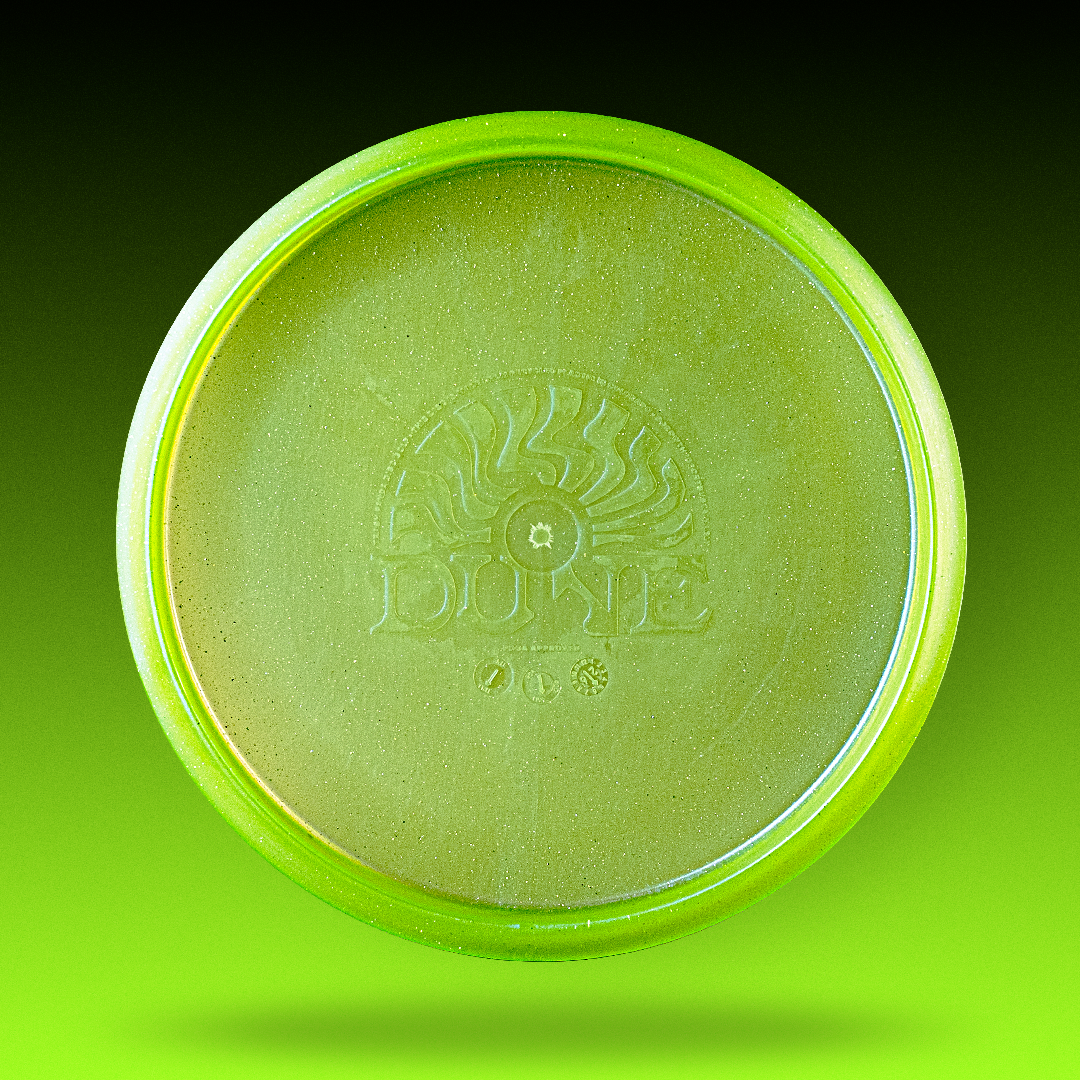 Studio shot of the green Trash Panda Metal Flake Dune disc golf midrange made from recycled plastic