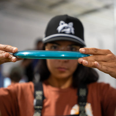 Maria Oliva holding a flat-top blue Frozen Trash Panda Dune
